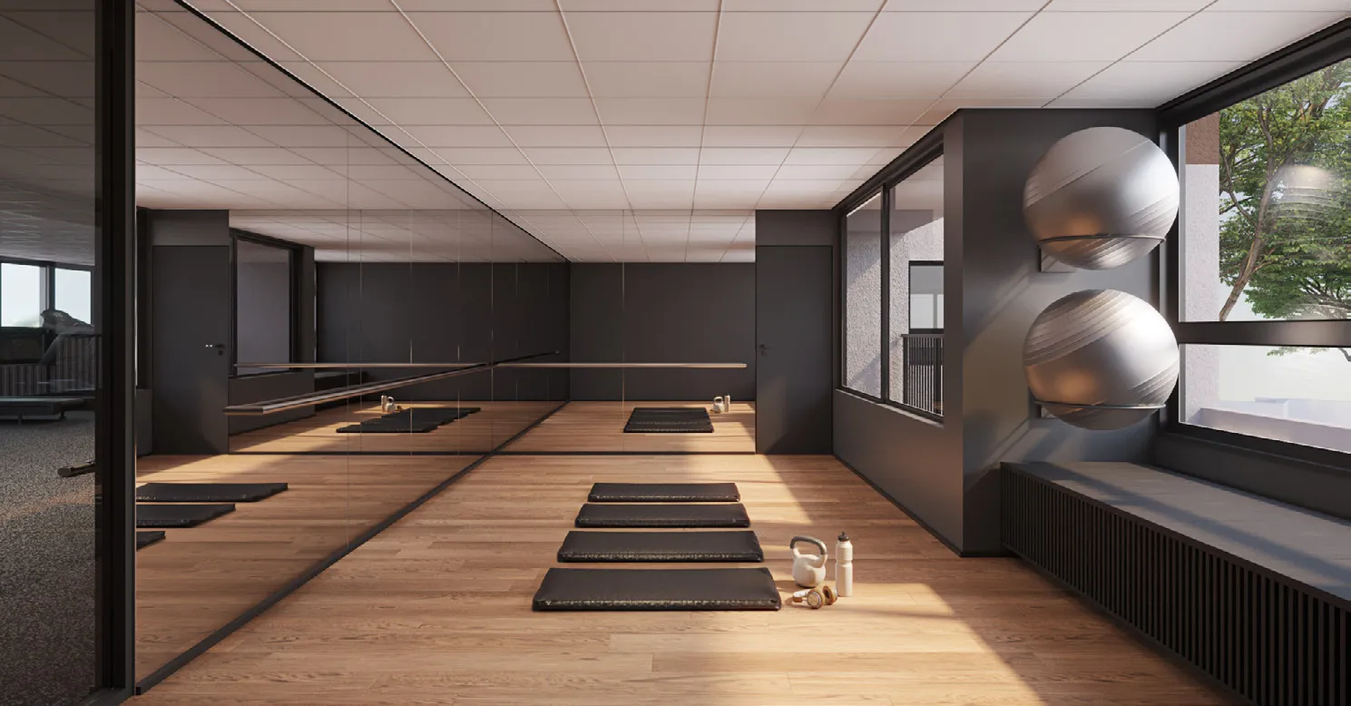 Sala multiuso com piso de madeira, espelhos, barra e colchonetes
